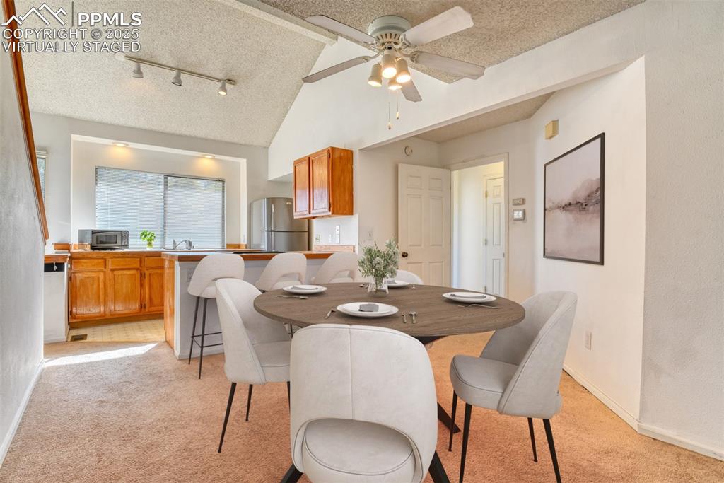 St, Unit A Colorado Springs, CO 80906 - Photo 11 of 37 a view of a dining room with furniture and a chandelier fan