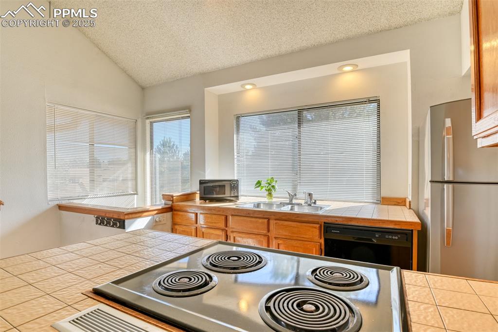 St, Unit A Colorado Springs, CO 80906 - Photo 15 of 37 a kitchen with a stove and a sink