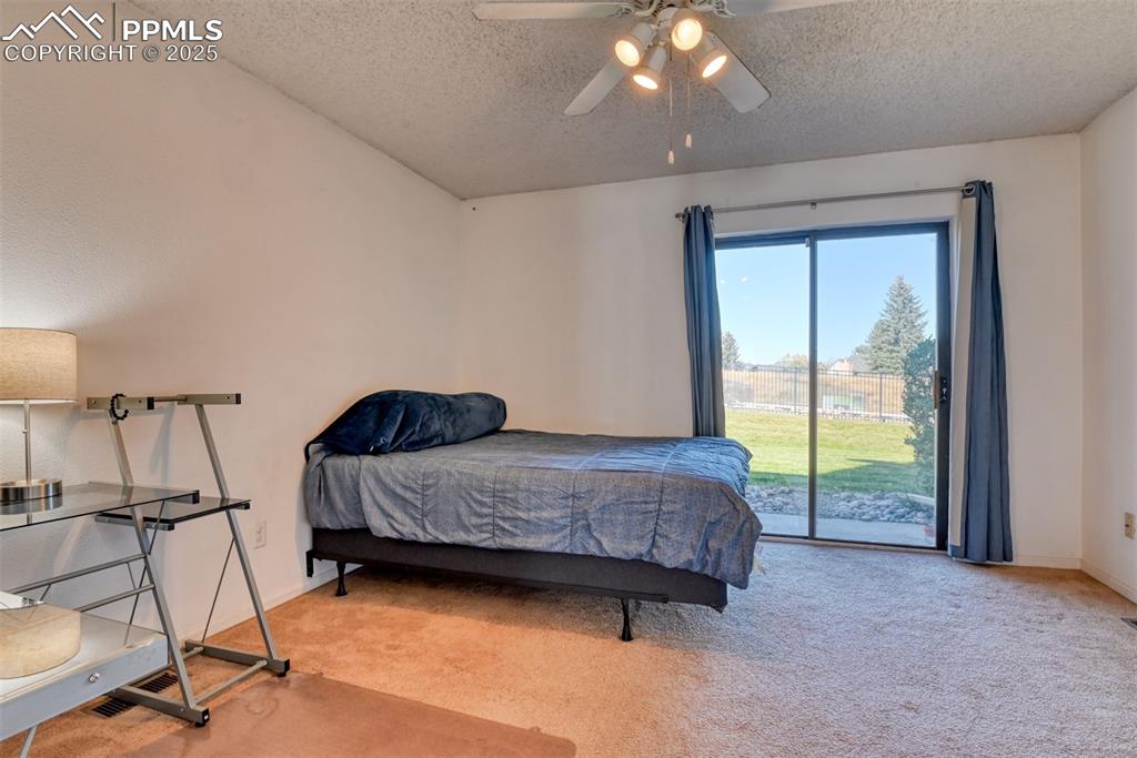 St, Unit A Colorado Springs, CO 80906 - Photo 16 of 37 a living room with a bed furniture and a large window