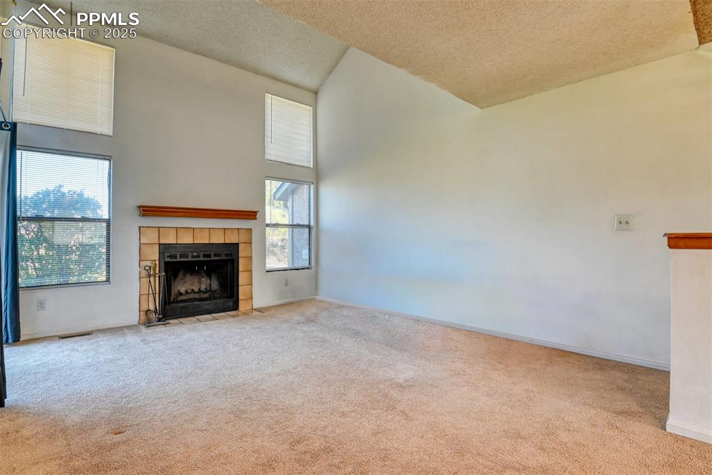 St, Unit A Colorado Springs, CO 80906 - Photo 17 of 37 a view of an empty room with a fireplace and a window