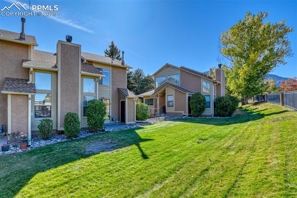 St, Unit A Colorado Springs, CO 80906 - Photo 2 of 37 a front view of a house with yard and green space