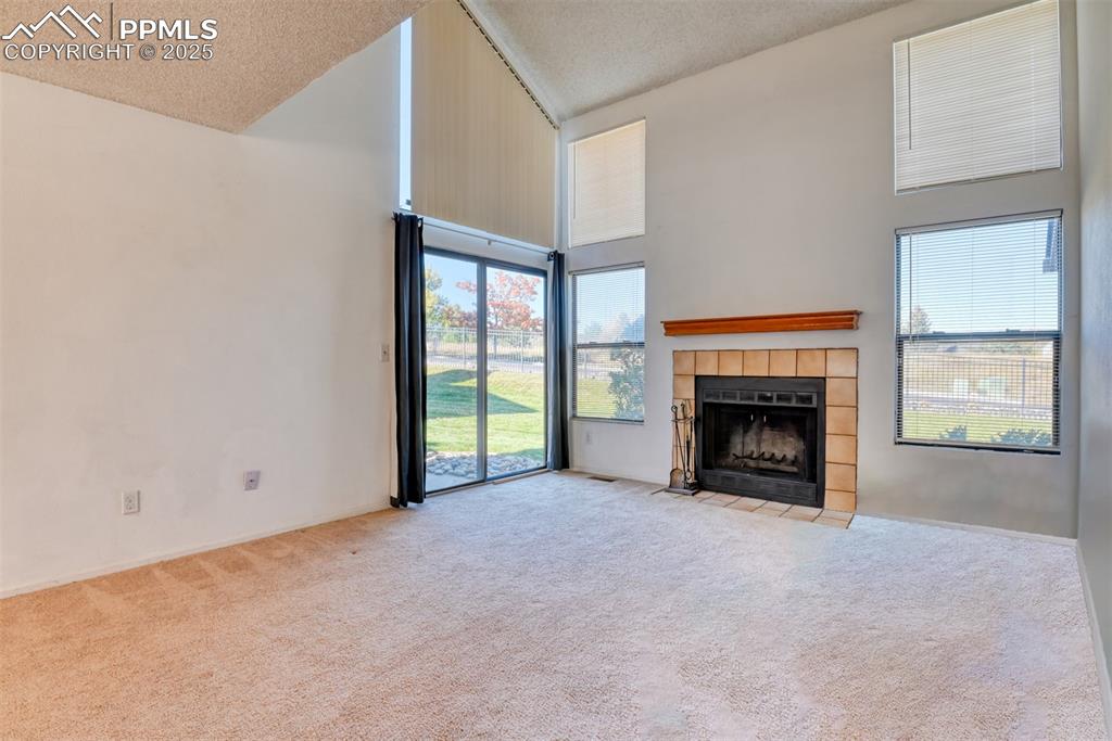 St, Unit A Colorado Springs, CO 80906 - Photo 21 of 37 a view of an empty room with a fireplace and a window