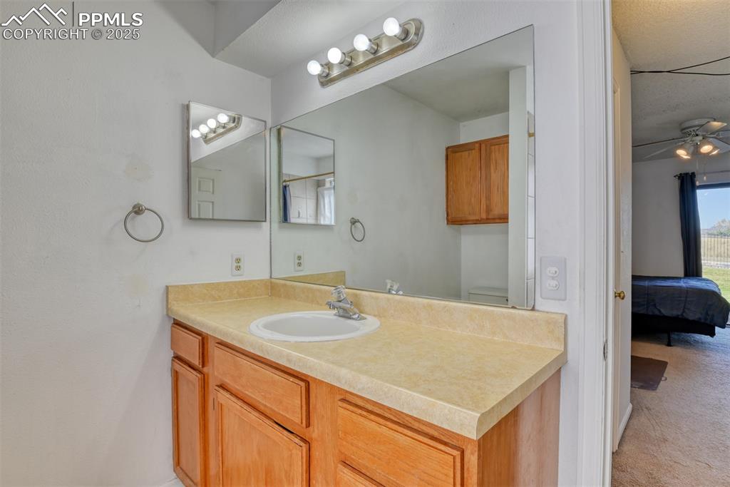 St, Unit A Colorado Springs, CO 80906 - Photo 25 of 37 a bathroom with a sink vanity and a mirror