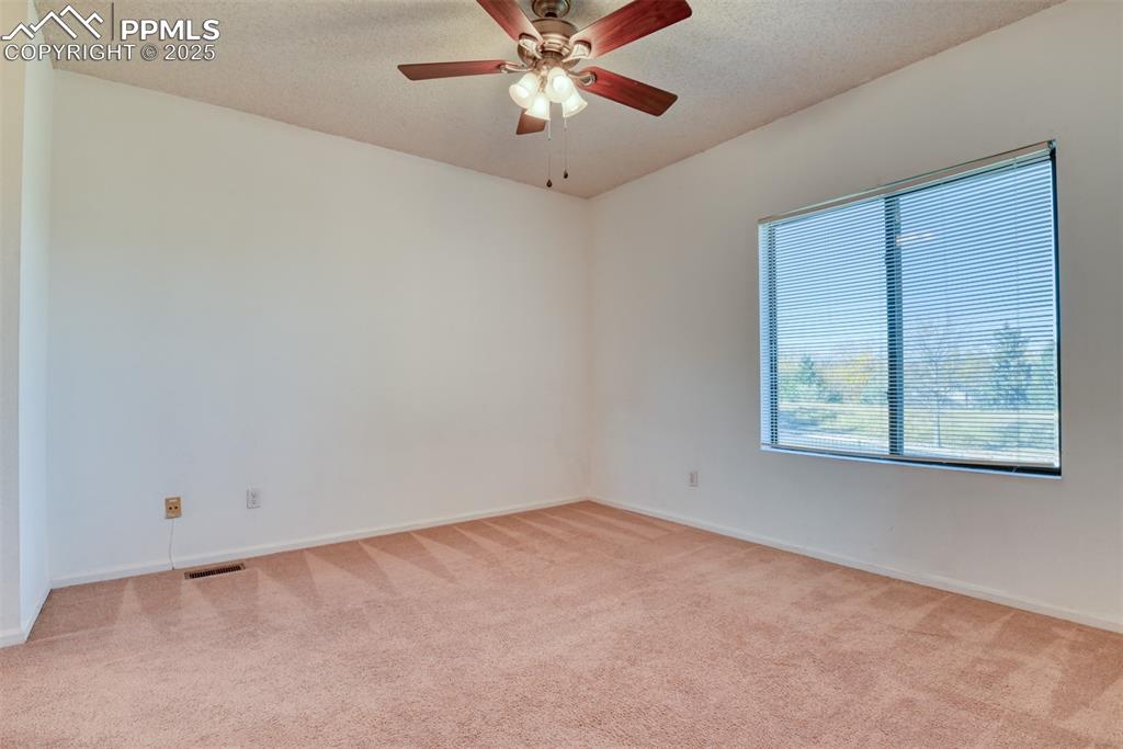 St, Unit A Colorado Springs, CO 80906 - Photo 27 of 37 an empty room with a window and a fan