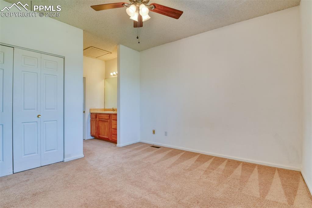 St, Unit A Colorado Springs, CO 80906 - Photo 28 of 37 an empty room with a chandelier fan and a bathroom