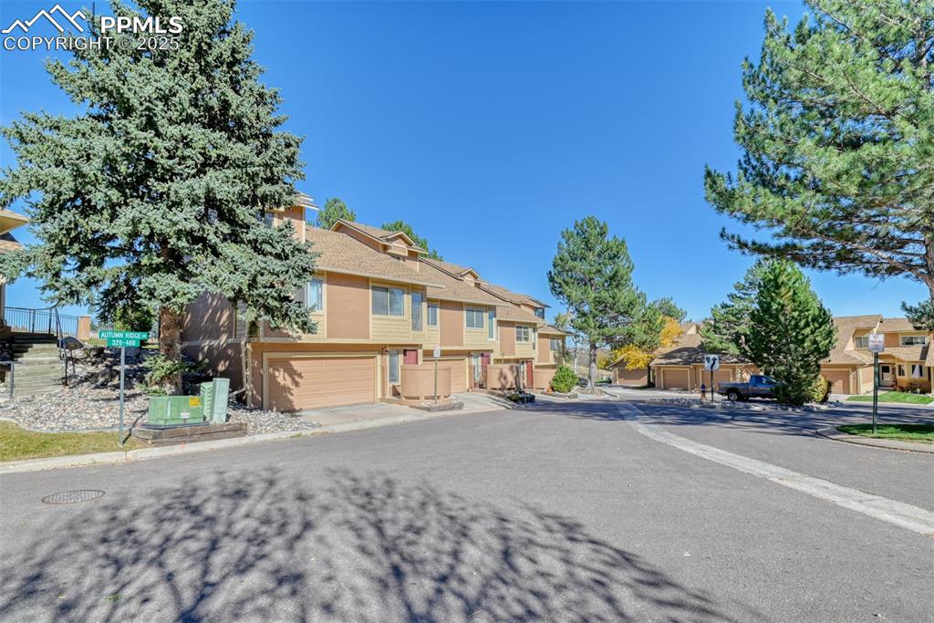 St, Unit A Colorado Springs, CO 80906 - Photo 32 of 37 a view of a house with a yard and garage
