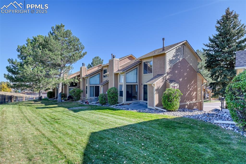 St, Unit A Colorado Springs, CO 80906 - Photo 33 of 37 a front view of a house with a yard and porch