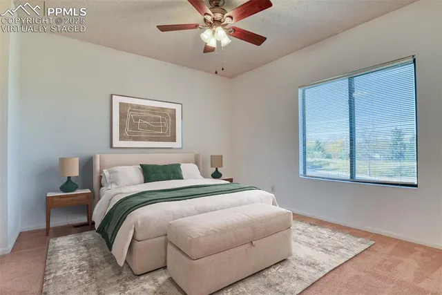 a bedroom with a bed and a painting on the wall