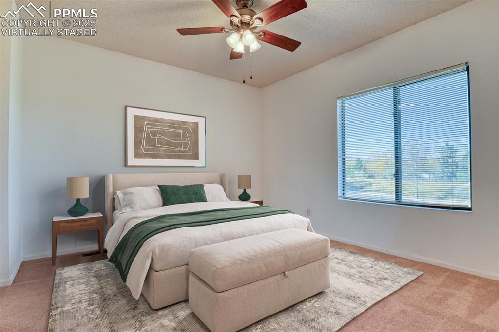 St, Unit A Colorado Springs, CO 80906 - Photo 7 of 37 a bedroom with a bed and a painting on the wall
