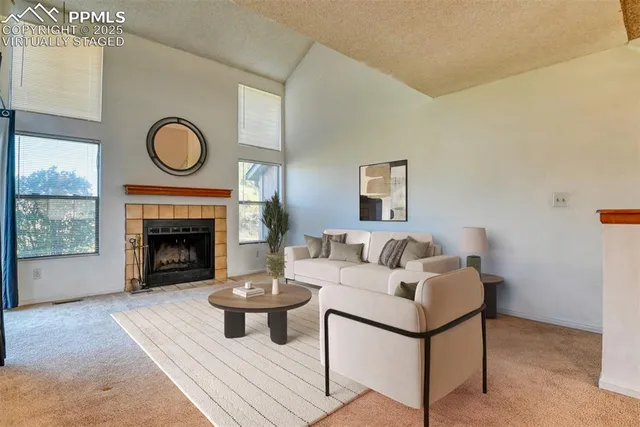 a living room with furniture a window and a fireplace