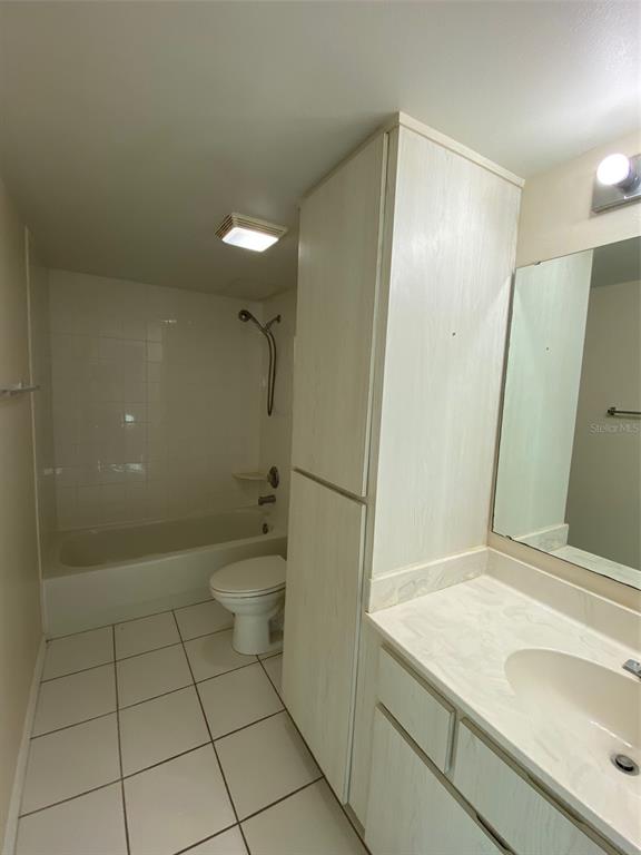 2911 Pecan Avenue Leesburg, FL 34748 - Photo 19 of 26 a bathroom with a granite countertop sink a toilet and shower