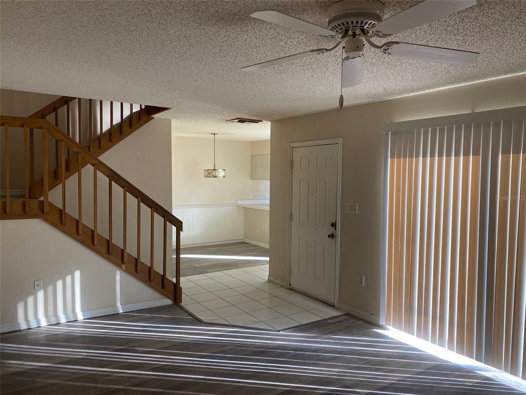 2911 Pecan Avenue Leesburg, FL 34748 - Photo 5 of 26 a view of staircase with white walls and railing