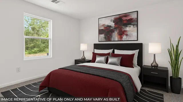 a bedroom with a bed and a painting on the wall