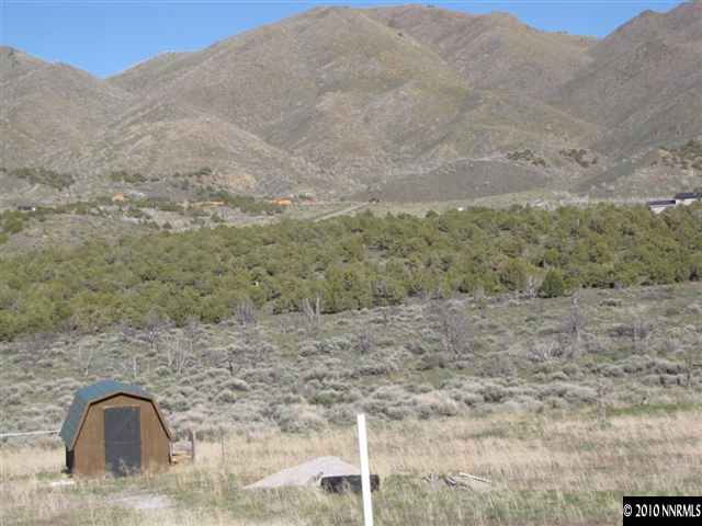 14465 Hope Lane, Unit 75 Reno, NV 89508 - Photo 3 of 7 a view of a dry yard with mountains and wooden fence