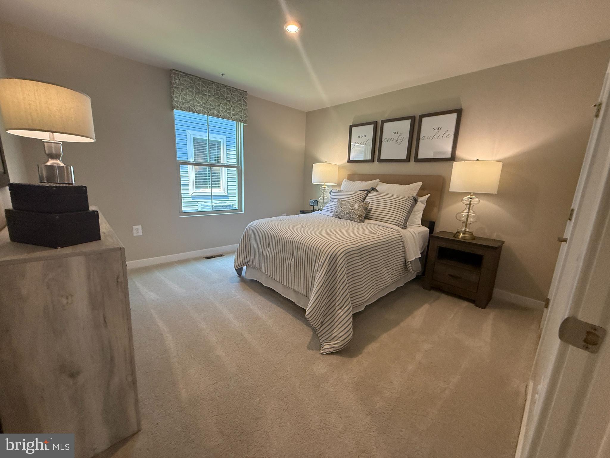 2506 Crown Point Circle Frederick, MD 21702 - Photo 16 of 21 a spacious bedroom with a bed and a lamp