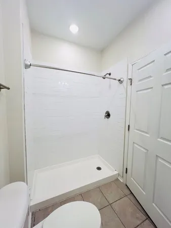 a bathroom with a shower and a toilet