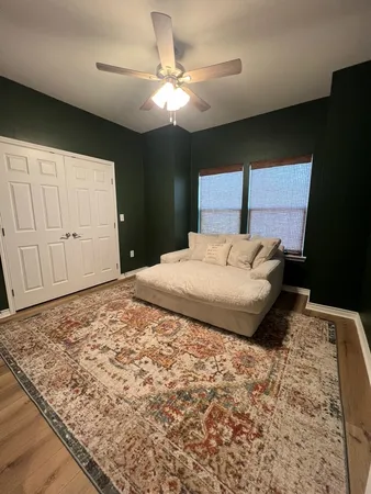 a bedroom with a large bed and a chandelier