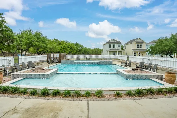 a view of a house with swimming pool and sitting area