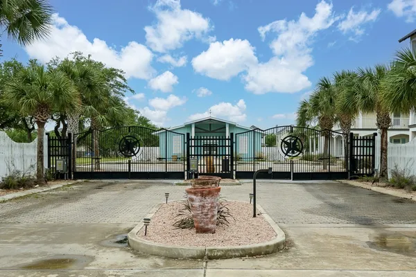 a view of a house with fountain in front of it