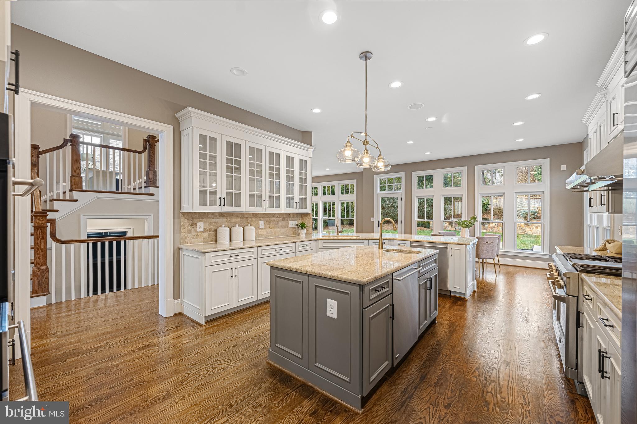 6520 Topeka Road McLean, VA 22101 - Photo 13 of 67 a kitchen with stainless steel appliances granite countertop a stove and a wooden floors