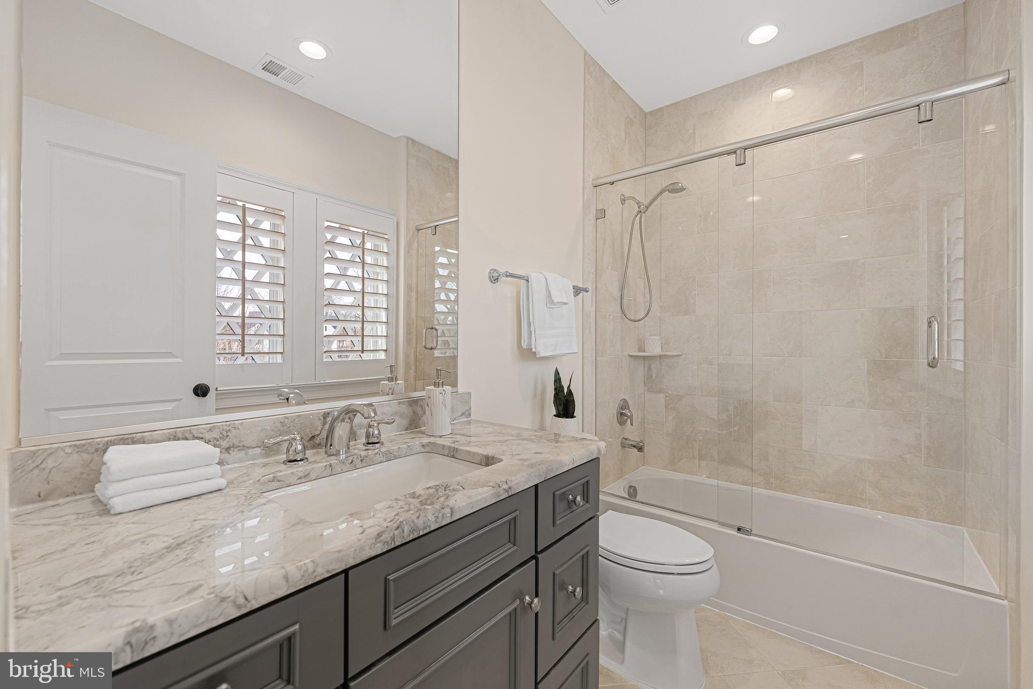 6520 Topeka Road McLean, VA 22101 - Photo 46 of 67 a bathroom with a granite countertop sink toilet and shower