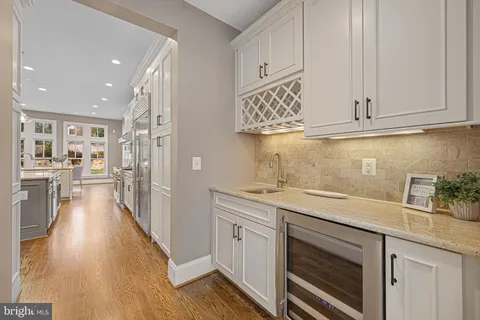 a kitchen with granite countertop white cabinets and stainless steel appliances