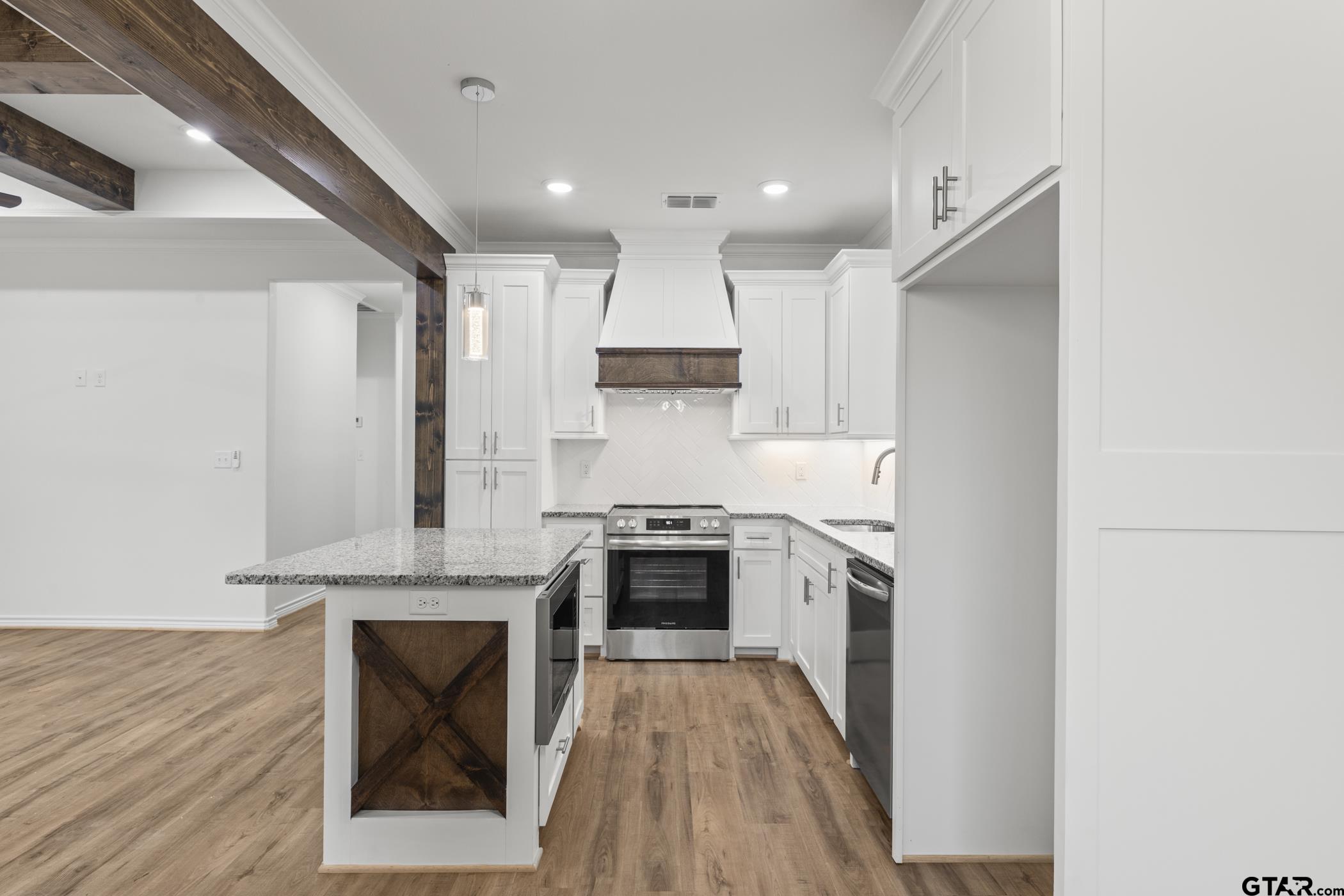 712 West 3rd Tyler, TX 75701 - Photo 15 of 28 a kitchen with stainless steel appliances granite countertop a stove and a refrigerator