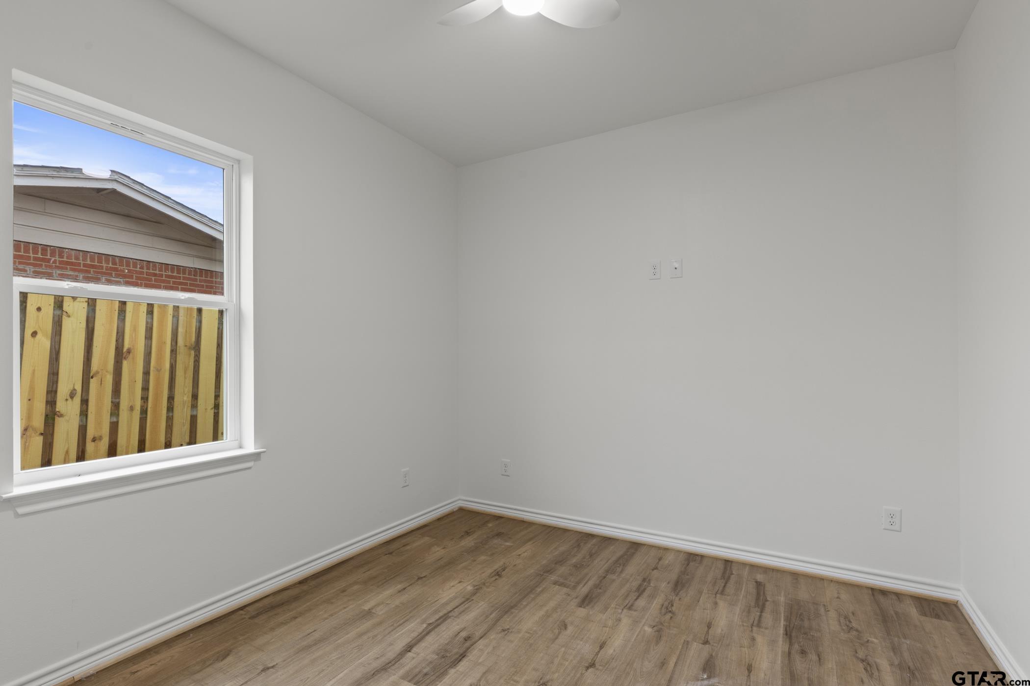 712 West 3rd Tyler, TX 75701 - Photo 27 of 28 a view of an empty room with wooden floor and a window