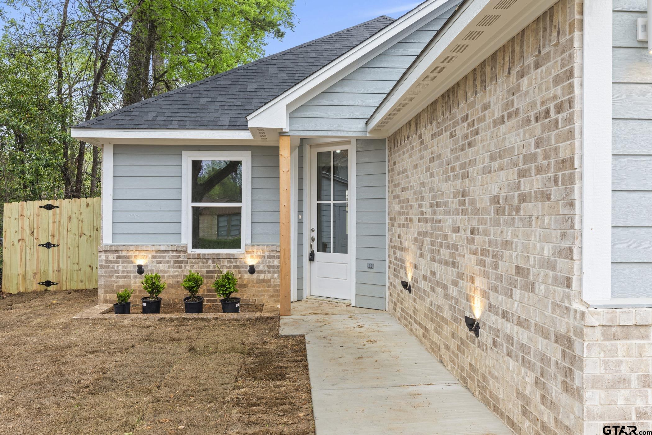 712 West 3rd Tyler, TX 75701 - Photo 4 of 28 a front view of a house with a yard