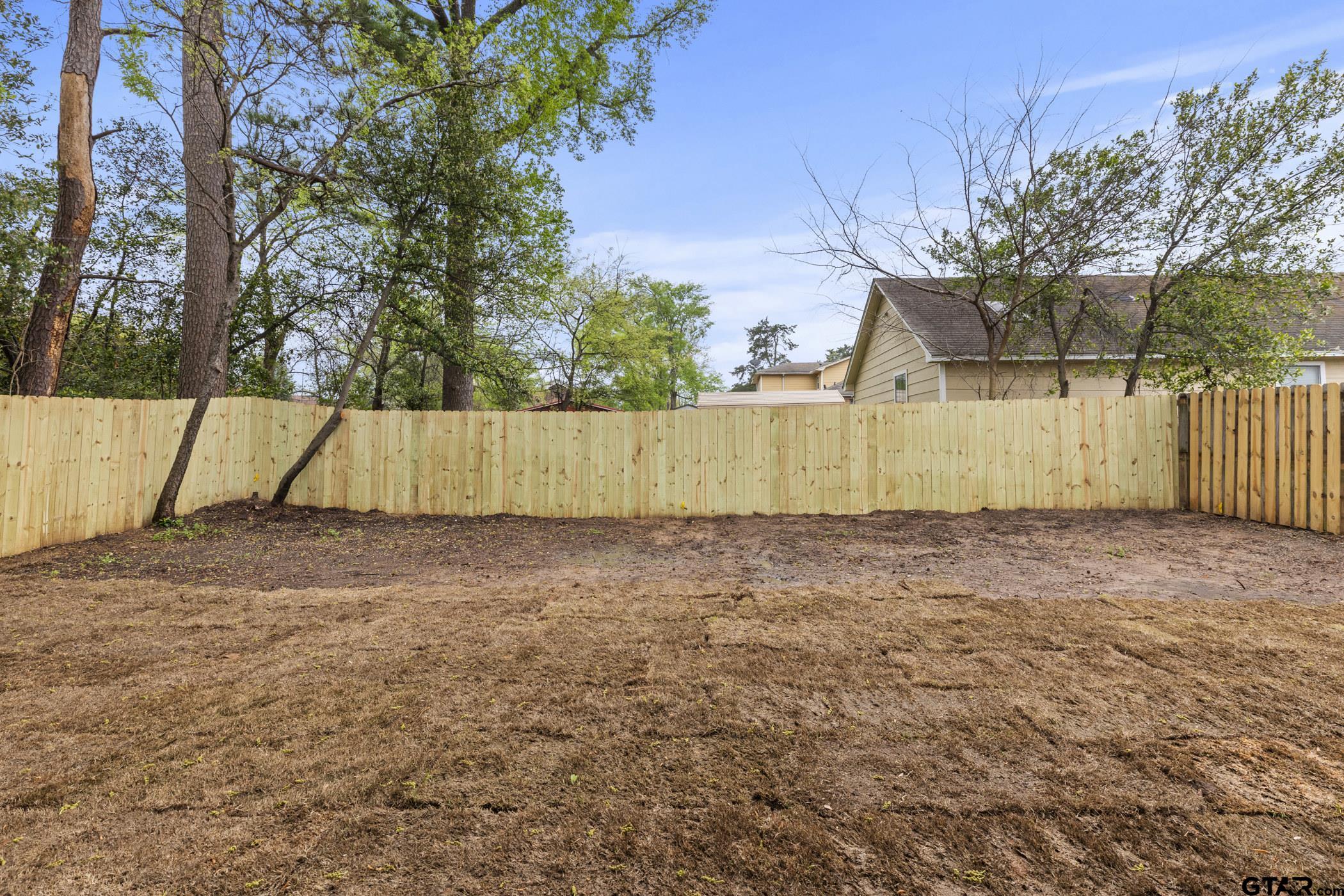 712 West 3rd Tyler, TX 75701 - Photo 7 of 28 a view of backyard with wooden fence