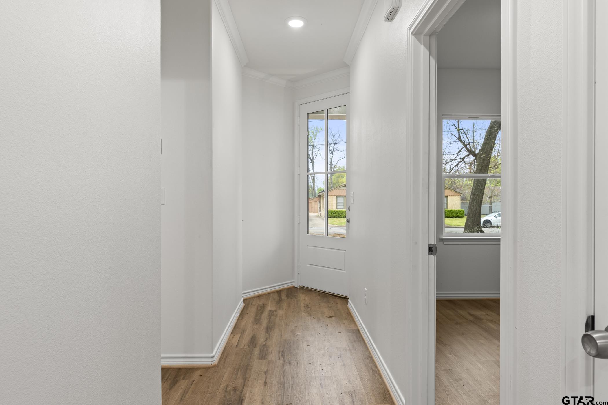 712 West 3rd Tyler, TX 75701 - Photo 8 of 28 a view of hallway with window and wooden floor