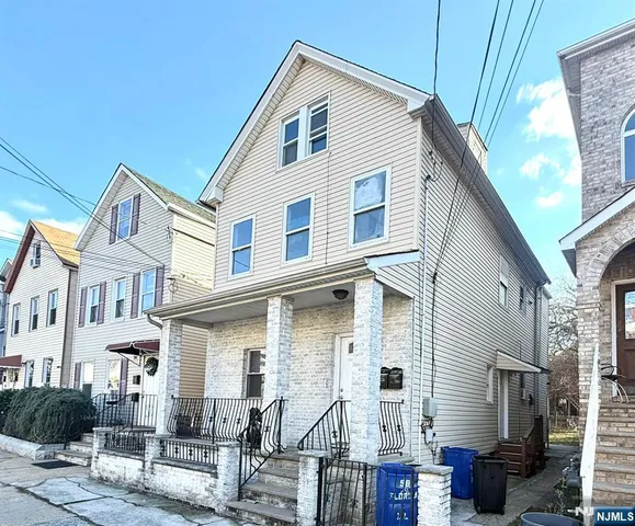 a view of a house with a small yard and furniture