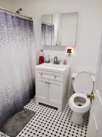 a kitchen with a refrigerator and a stove top oven