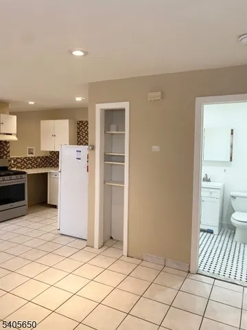 a view of a white house with a yard