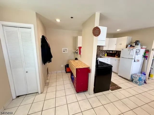 a kitchen with a refrigerator and cabinets