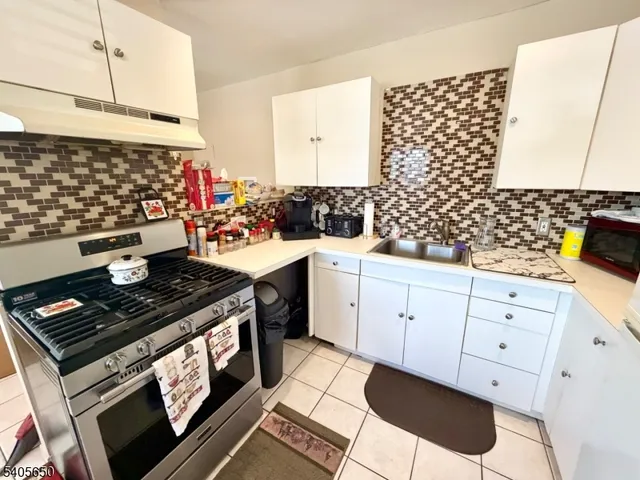 a kitchen with a sink and wooden cabinets
