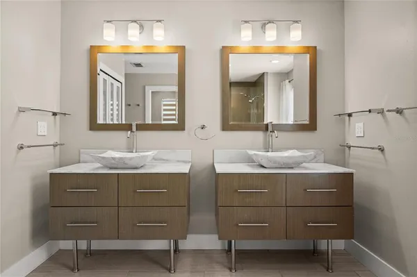a bathroom with a sink vanity and mirror