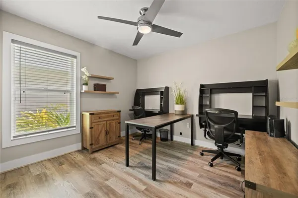 a view of a workspace with furniture and a window