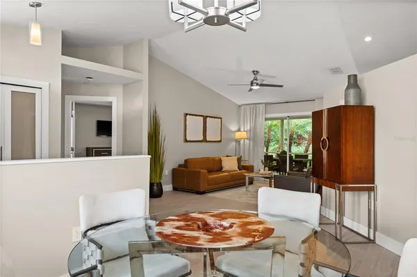 a living room with furniture a fireplace and a chandelier