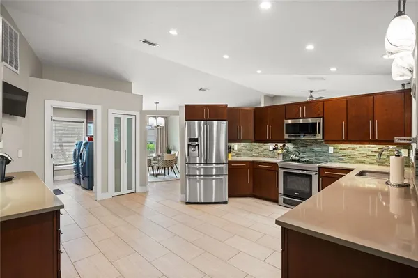 a kitchen with a sink stainless steel appliances and cabinets