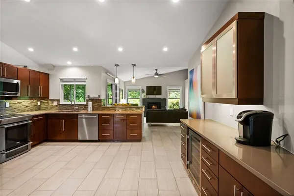 a kitchen with stainless steel appliances granite countertop a sink dishwasher stove and refrigerator