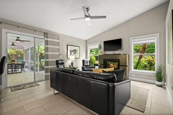 a living room with furniture a fireplace and a flat screen tv