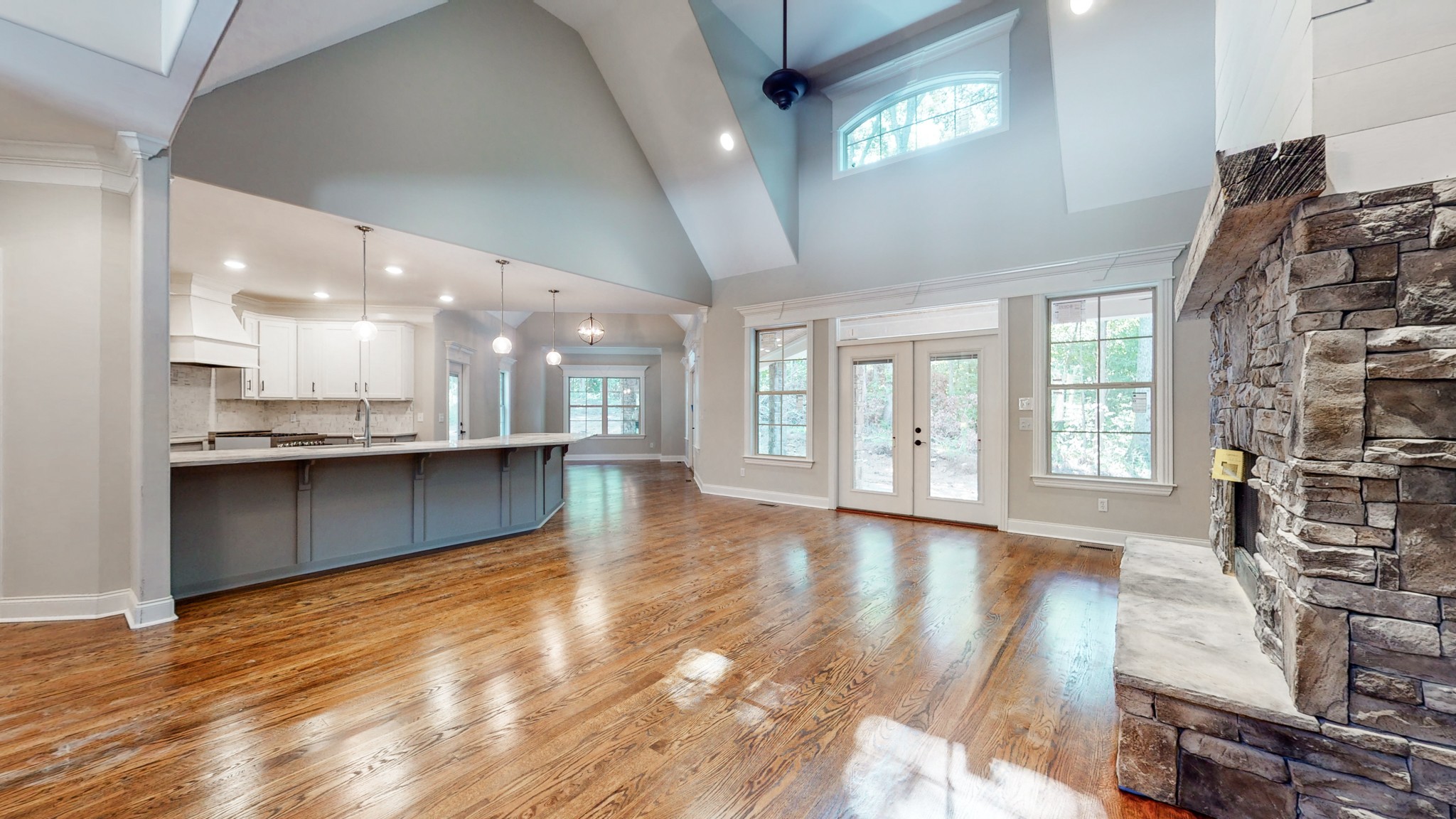 3191 B Greens Mill Road Spring Hill, TN 37174 - Photo 1 of 50 a view of an empty room with wooden floor and a kitchen