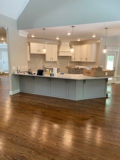 3191 B Greens Mill Road Spring Hill, TN 37174 - Photo 7 of 50 a view of a kitchen with kitchen island a sink wooden floor and a counter top space