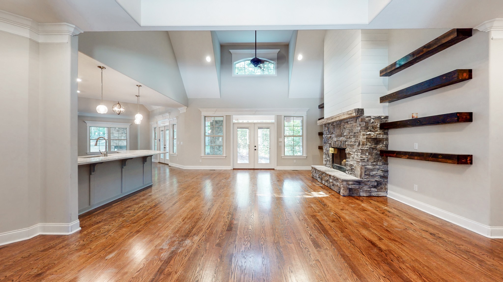 3191 B Greens Mill Road Spring Hill, TN 37174 - Photo 9 of 50 a view of an empty room and a kitchen with wooden floor