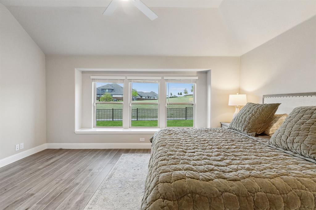 2137 Charming Frg Road Forney, TX 75126 - Photo 18 of 35 a large bed sitting in a bedroom next to a window