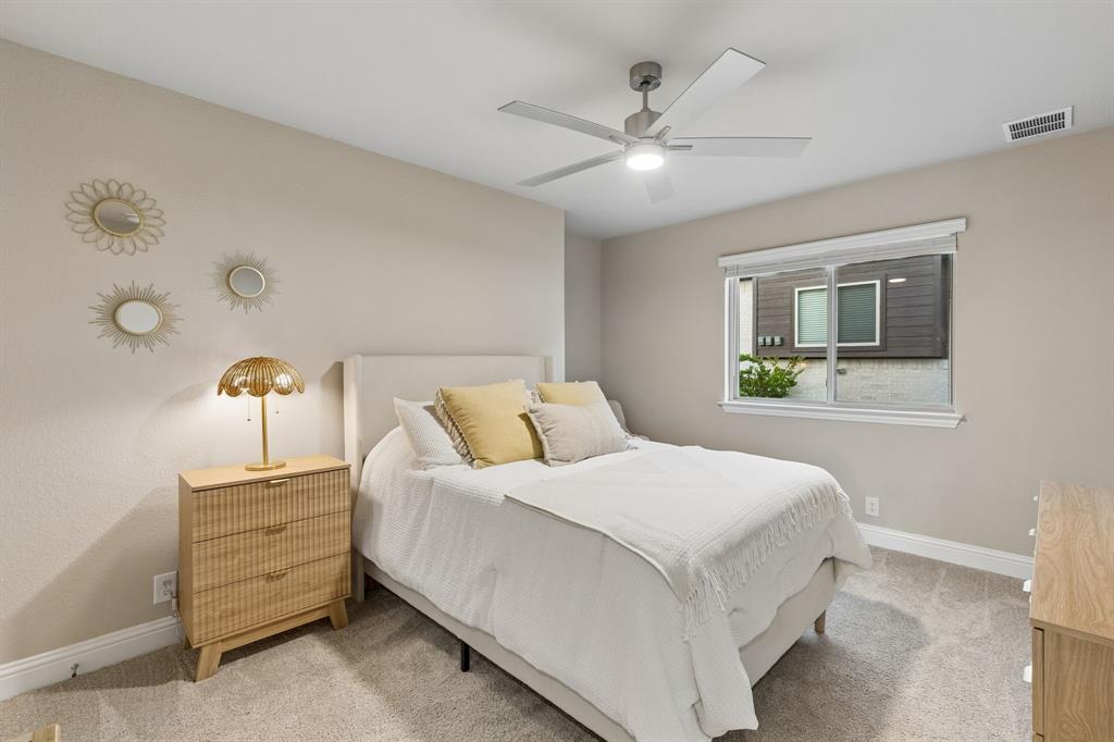 2137 Charming Frg Road Forney, TX 75126 - Photo 21 of 35 a bedroom with a bed and a chandelier