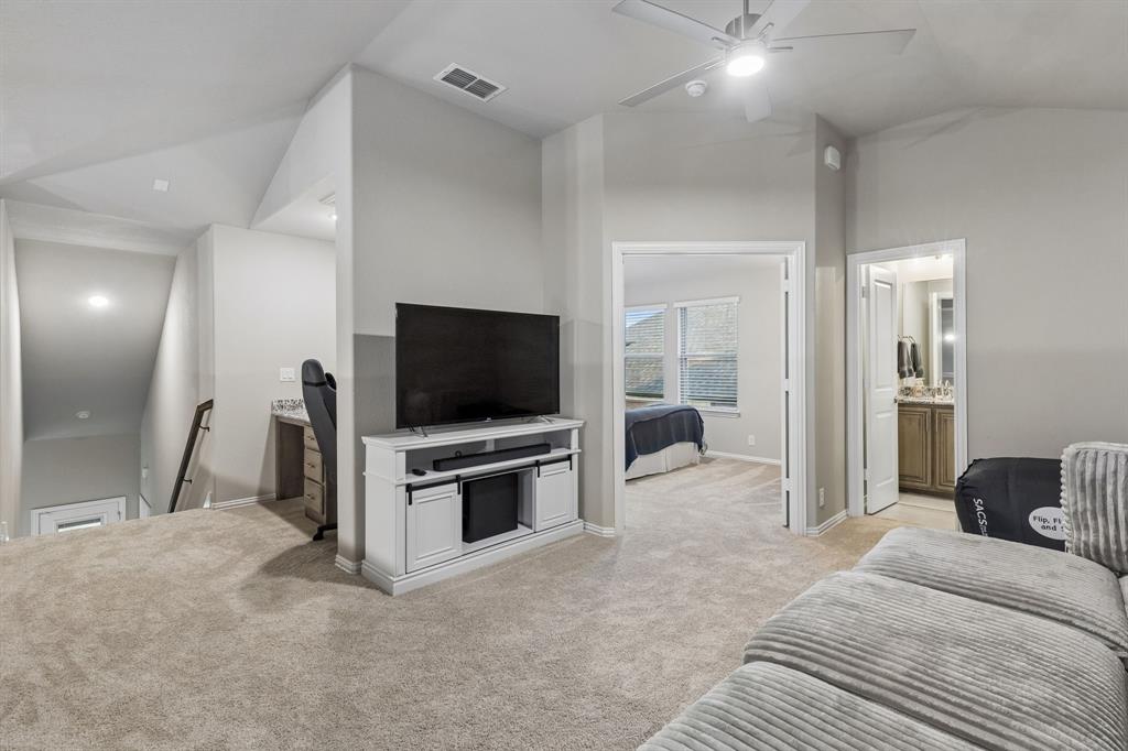 2137 Charming Frg Road Forney, TX 75126 - Photo 26 of 35 a view of a livingroom with a flat screen tv