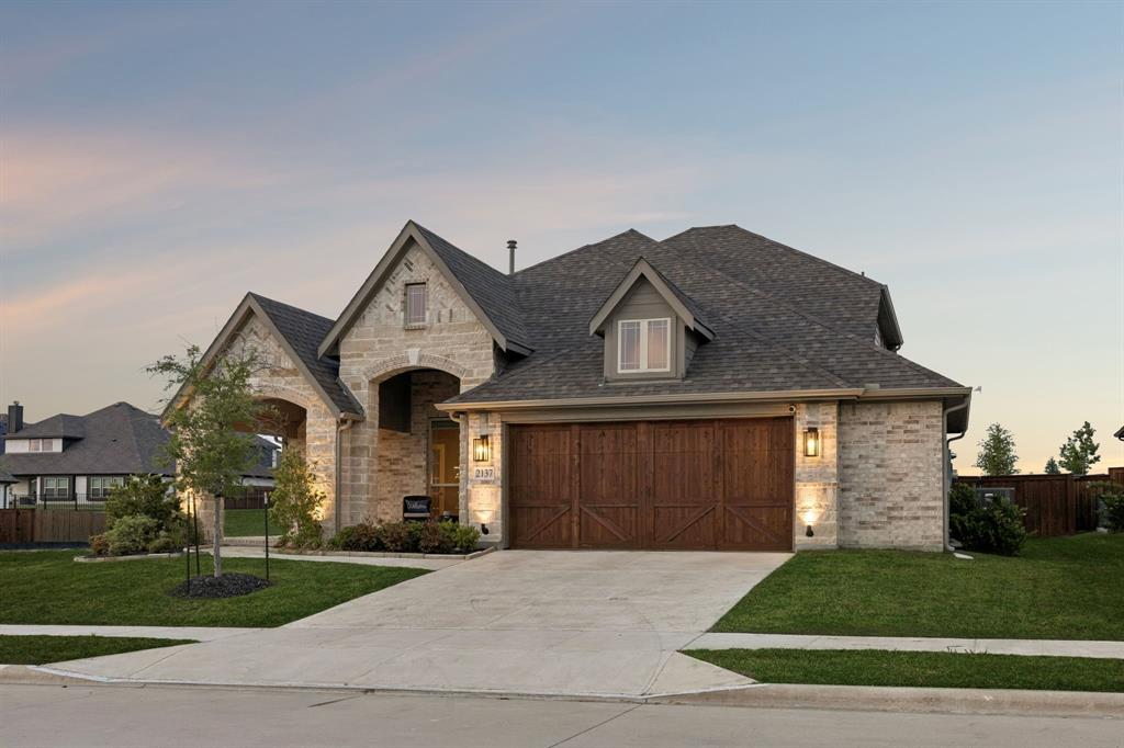 2137 Charming Frg Road Forney, TX 75126 - Photo 29 of 35 a front view of a house with a garden