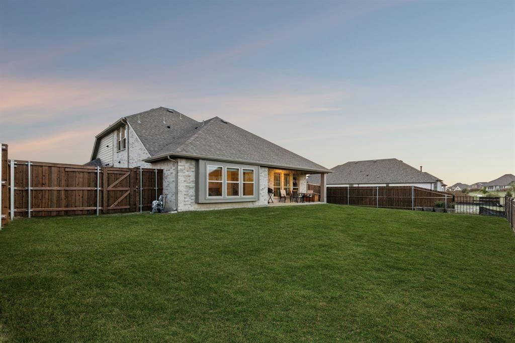 2137 Charming Frg Road Forney, TX 75126 - Photo 32 of 35 a house that is sitting in the grass with large trees